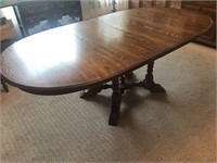 Oak, oval dining table with leaves.