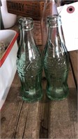 Two Coca-cola glass bottles