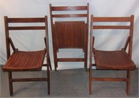 3 wooden folding chairs.