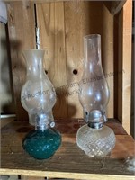 2 oil lamps. One with a clear base and one with a