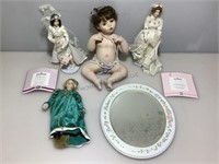 Mirror and assorted collectible dolls.
