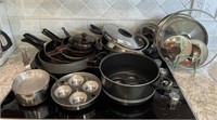 Pots and pans and lids on top of stove