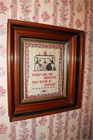 Shadow box frame containing an old sampler -