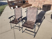 Two folding lawn chairs.