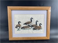 Adorable needle point of flock of Canadian geese m