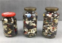 3 glass jars of buttons