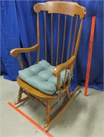 spindle back rocker with green cushion