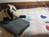 Well loved quilt, stuffed sheep and throw blanket