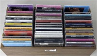 Collection of Elvis Presley CDs in Wooden Rack