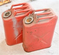 Pair of red metal Jerry style fuel cans.
