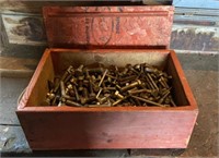 Assortment of bolts and nuts in a wooden storage