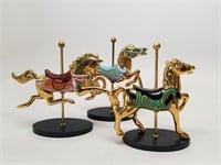 Three Gold-Colored Carousel Horses