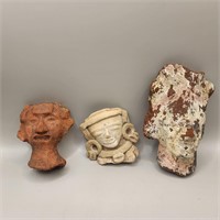 Three Pre-Columbian heads, one of them painted
