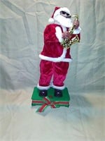 Saxophone Santa. Sings and dances. 14 in tall.