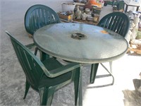 ROUND GLASS-TOP PATIO TABLE AND 3 PLASTIC CHAIRS