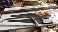 4 foot wooden American level, two handsaw’s, and