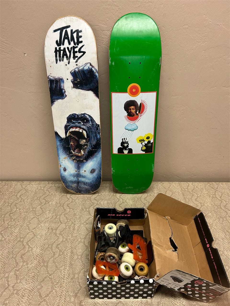 2 skateboard decks + box of misc. parts. Kong+Jimi