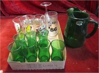 Green glass pitcher matching glasses and more.