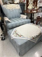 Blue upholstered chair with ottoman.