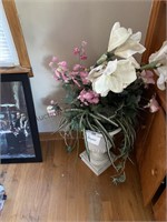 Flower arrangement in a white planter. Planter