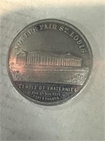 The St. Louis World Fair token, showing the