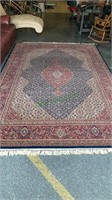 Large room size carpet with a burgundy and blue