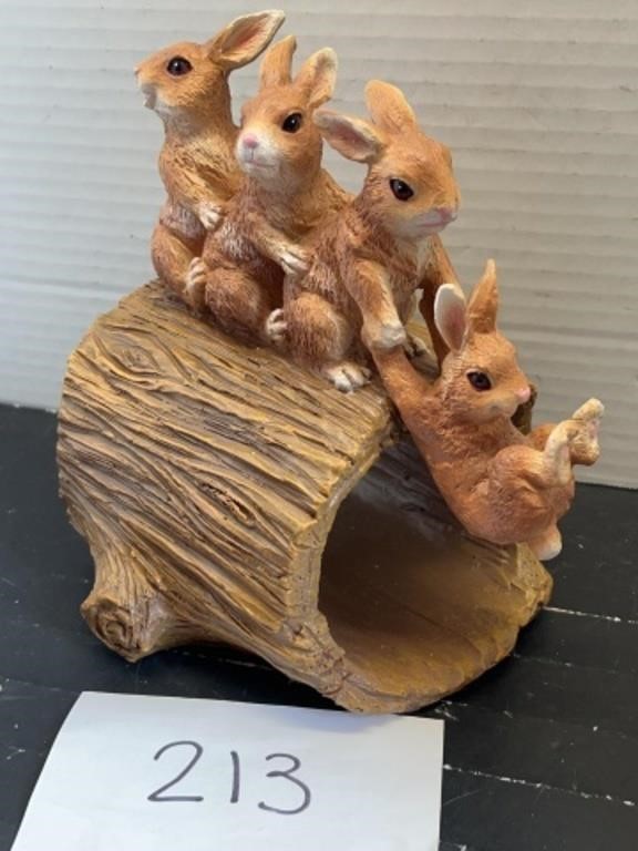 Ceramic bunnies on a log garden decor