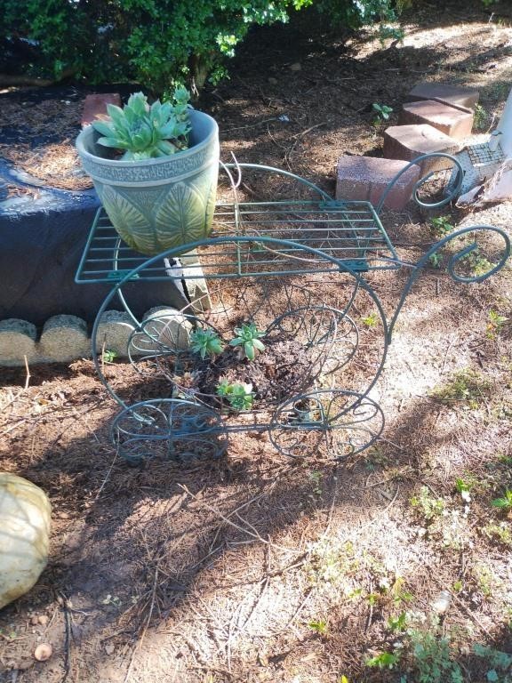 Metal wagon plant stand with plants