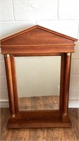 Wood frame with pillars on sides, brass accents,