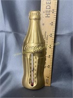 Coca-cola gold finish embossed 7in advertising