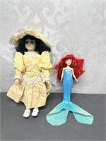 Plastic doll with yellow dress has