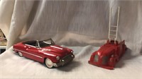 Two vintage toys.  Metal car.  Plastic fire truck