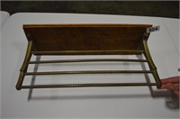Old brass drying rack or towel rack on wood