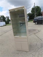 Lighted glass display case w/drawers.