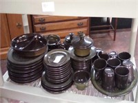 Shelf of green and Brown dishes