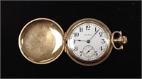 One gold tone Elgin ladies pocket watch, one side