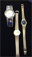 Three ladies dress watches including a gold tone