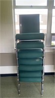 7 green padded metal chairs