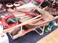 Wheelbarrow with six hand tools: hatchet,