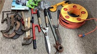 Tote of 6 metal c clamps, reel of extension cord,