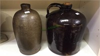 Two pottery jugs, one with the handle  with