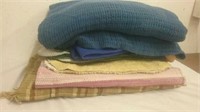 Group of heavy blankets and bath mats