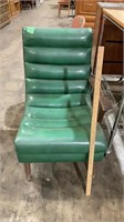 Green chair, missing an arm