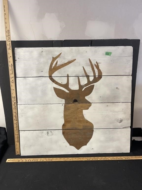 Painted deer head on board