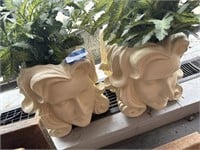 Face flower pots with faux plants