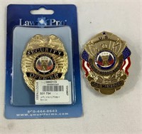 Two metal security badges