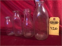 Four Milk Bottles