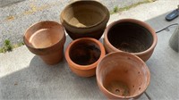 5 large planters, 4 are terracotta