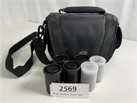 A camera case with several film canisters, some