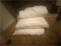 2 pillows, two mattress pads w/ tote